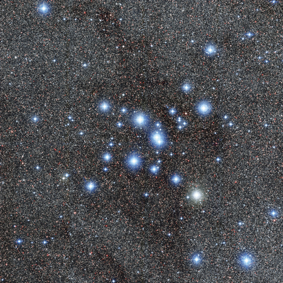 The colored image shows a white-blue star cluster against the background of the black universe.